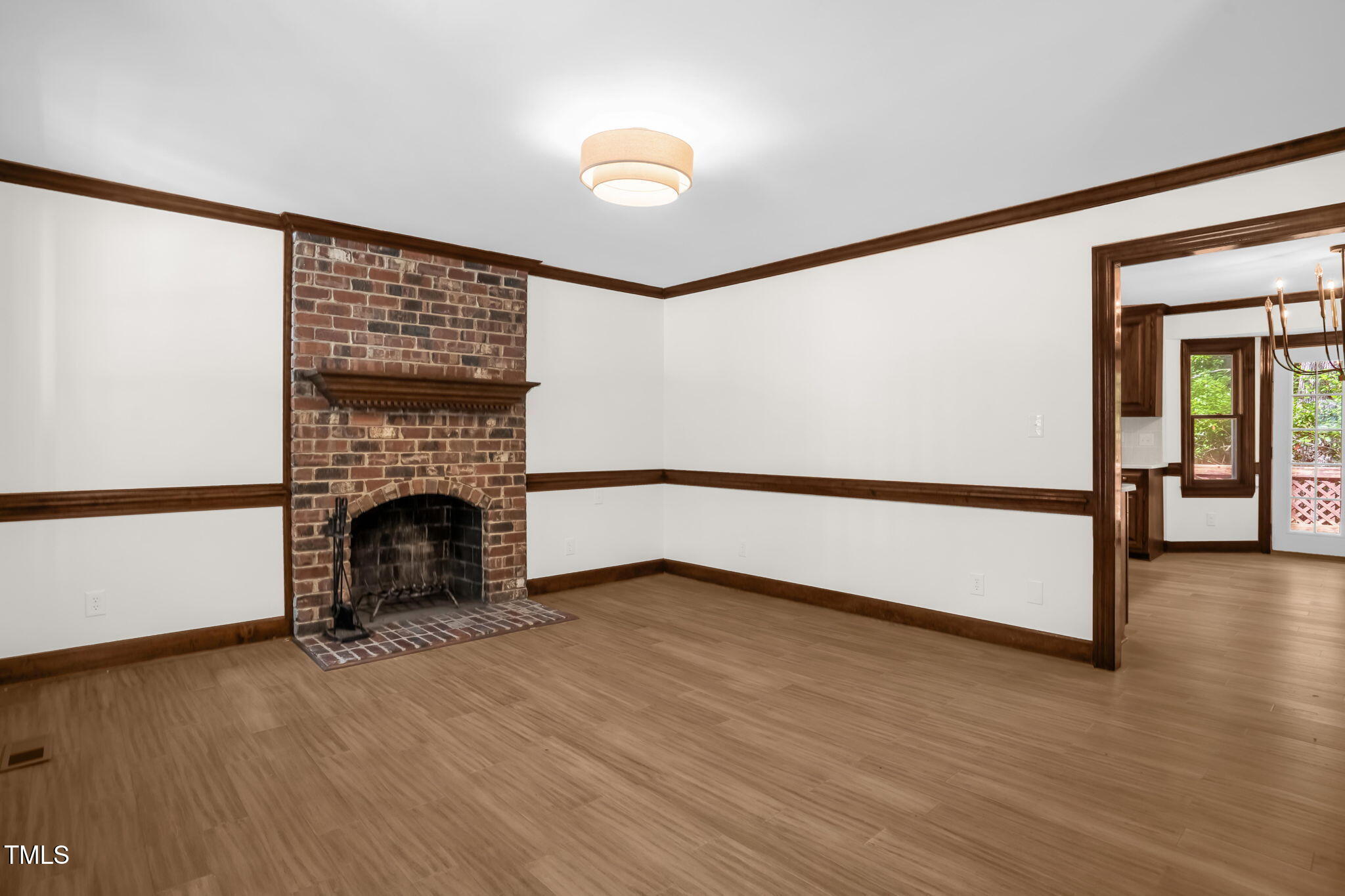 616 Cross Timbers Drive Durham, NC 27713 - Photo 3 of 29 a view of empty room with wooden floor and fireplace