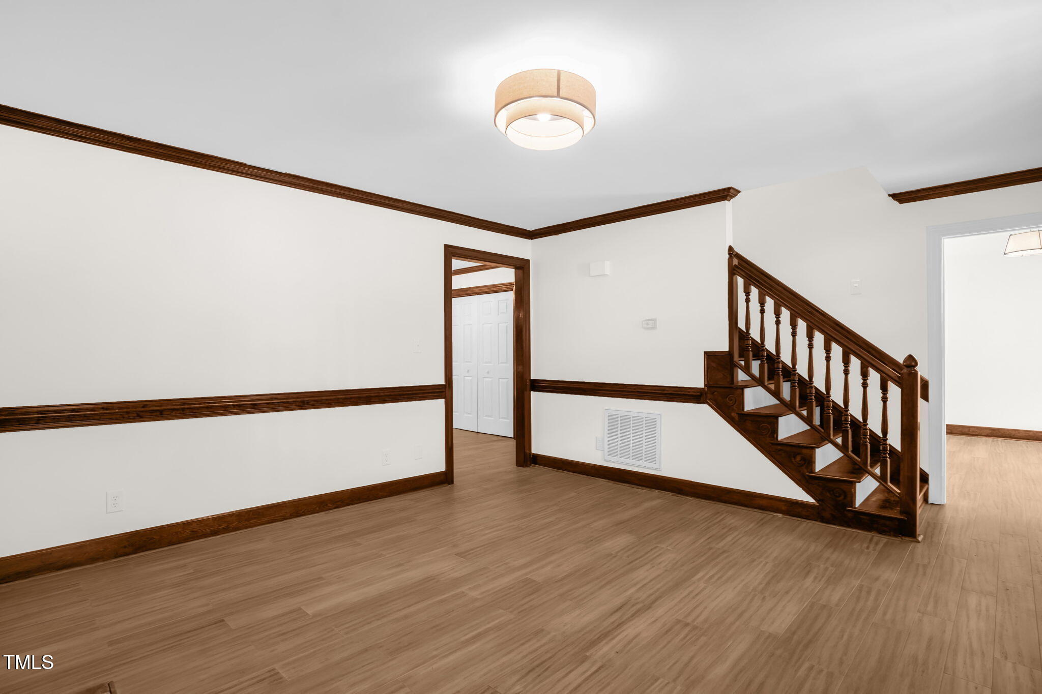 616 Cross Timbers Drive Durham, NC 27713 - Photo 7 of 29 a view of an empty room with wooden floor and stairs