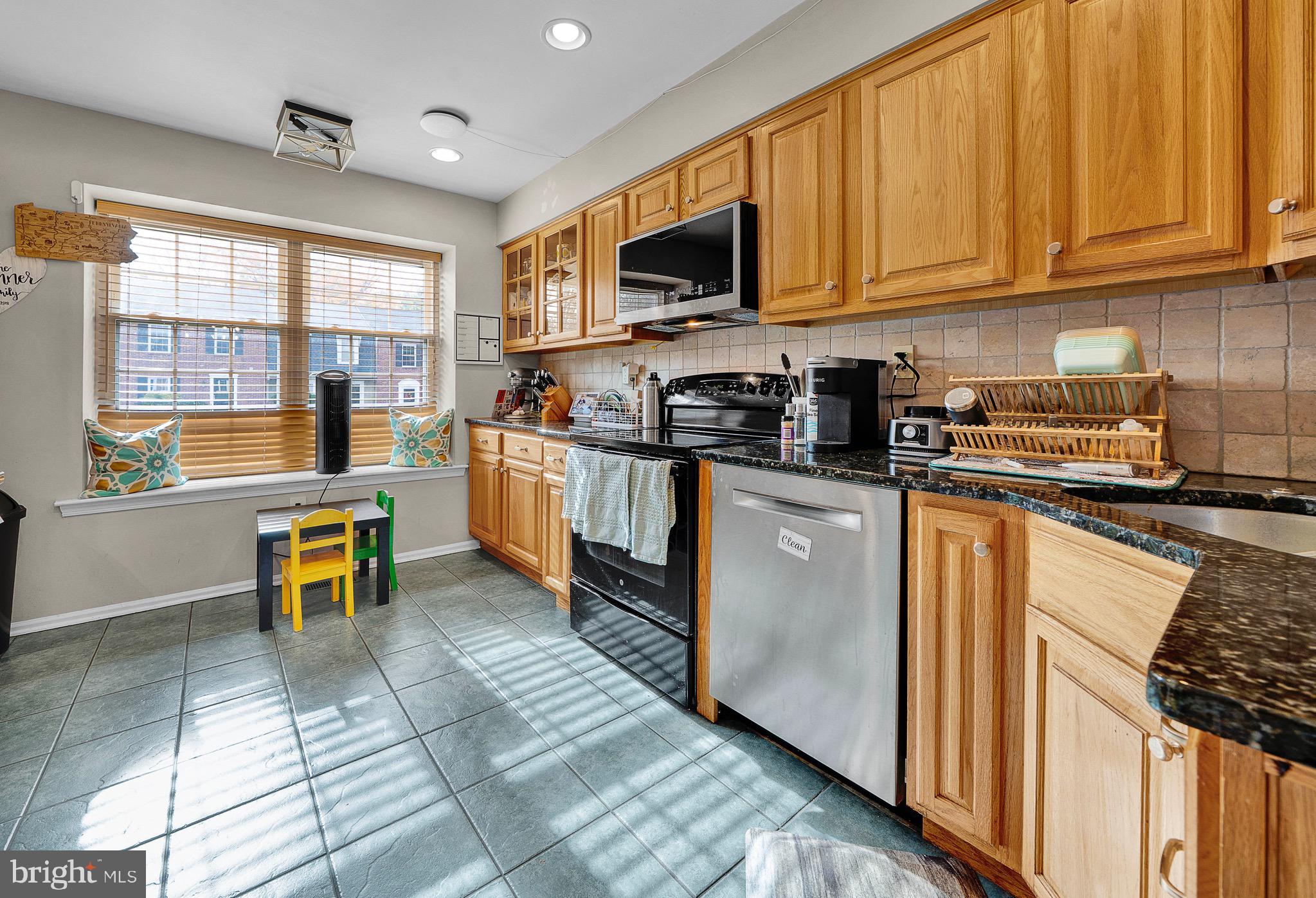 301 Cherokee Circle Ambler, PA 19002 - Photo 11 of 39 a kitchen with stainless steel appliances granite countertop a stove a sink and a microwave