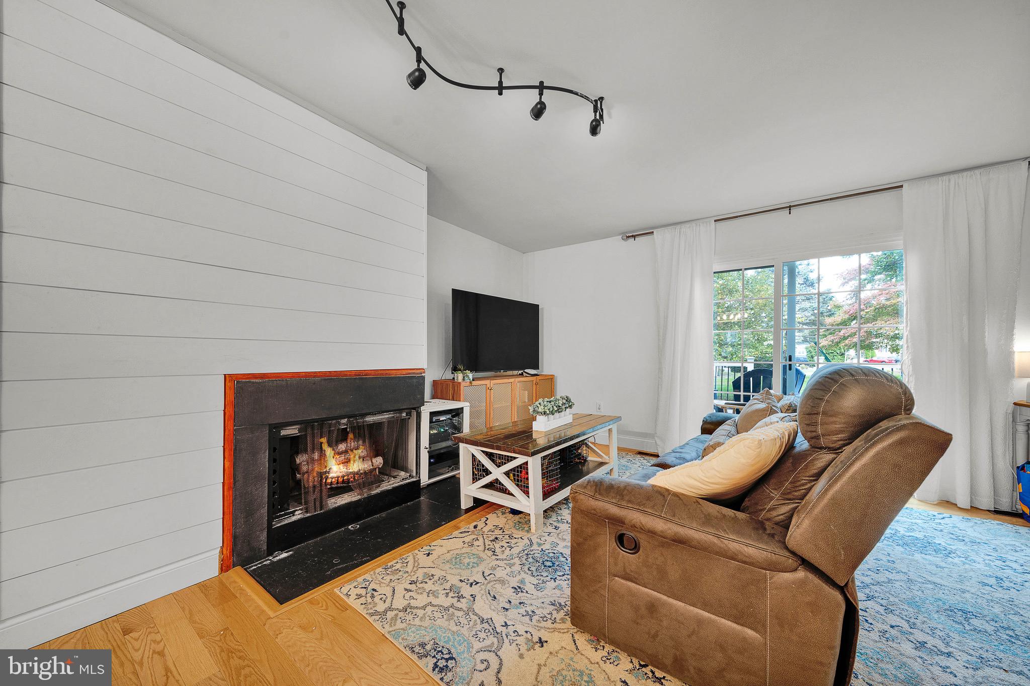 301 Cherokee Circle Ambler, PA 19002 - Photo 21 of 39 a living room with furniture a flat screen tv and a fireplace