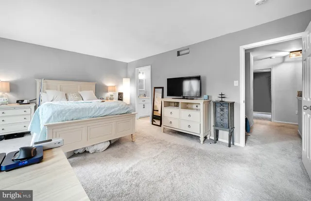 a bedroom with furniture and a flat screen tv