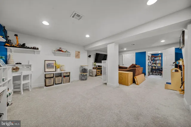 a view of a livingroom with furniture and a to ceiling window