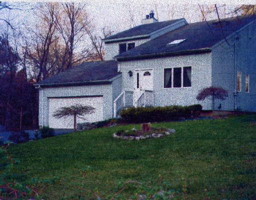 75 Mile Hill Road South Newtown, CT 06470 - Photo 1 of 1 a front view of a house with a garden and plants