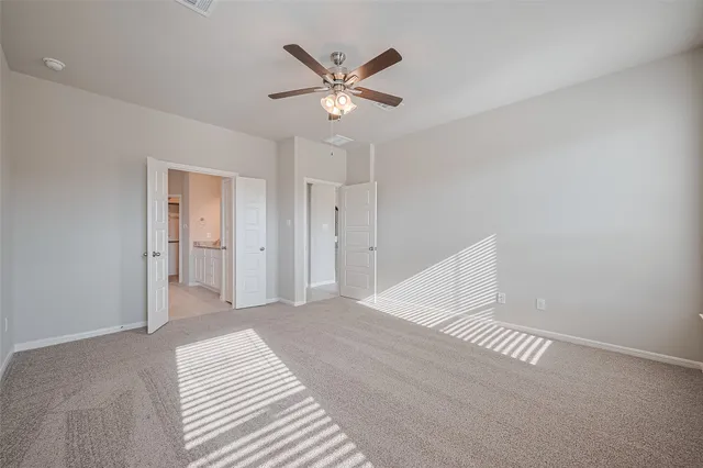 a view of a livingroom with a ceiling fan and wooden floor