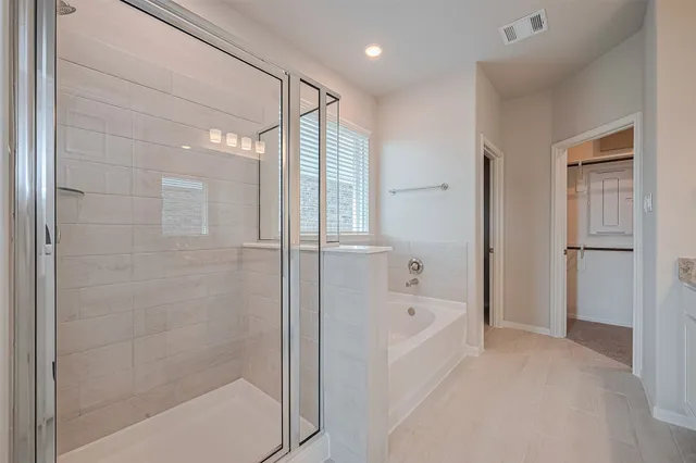 a bathroom with a bathtub and a shower