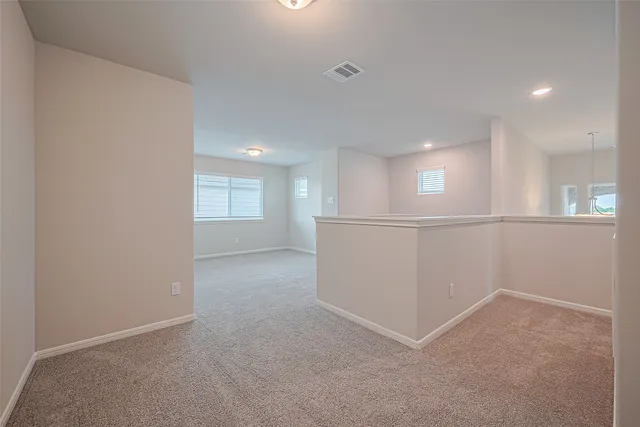 a view of an empty room and a window