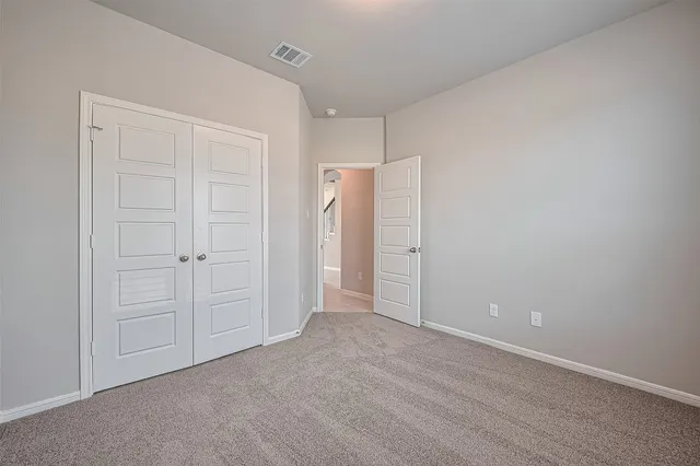 an empty room with closet area