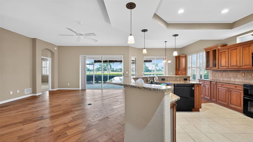 3959 San Rocco Drive, Unit 412 Punta Gorda, FL 33950 - Photo 11 of 41 a large kitchen with stainless steel appliances granite countertop a lot of counter space and wooden floors