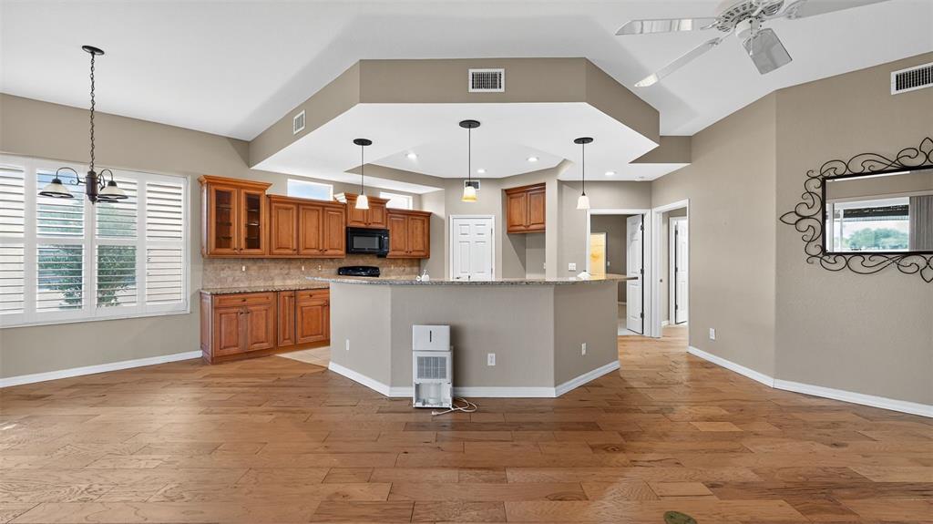 3959 San Rocco Drive, Unit 412 Punta Gorda, FL 33950 - Photo 13 of 41 a large kitchen with kitchen island a sink a counter space and stainless steel appliances