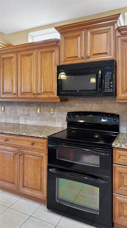 3959 San Rocco Drive, Unit 412 Punta Gorda, FL 33950 - Photo 17 of 41 a kitchen with granite countertop a stove microwave and cabinets