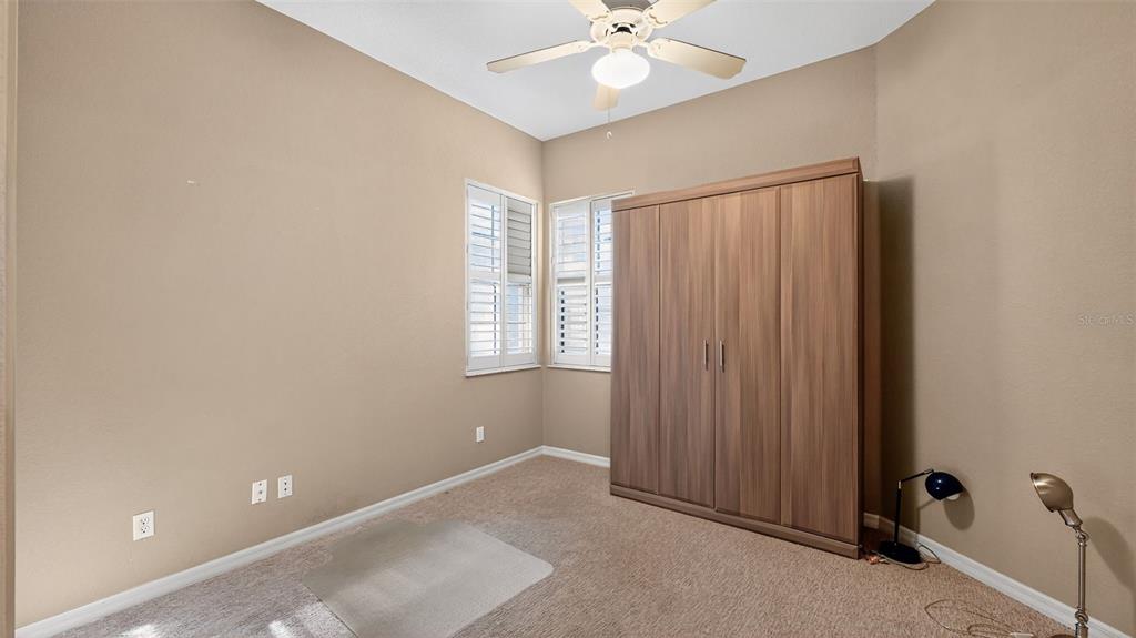 3959 San Rocco Drive, Unit 412 Punta Gorda, FL 33950 - Photo 30 of 41 an empty room with windows and fan