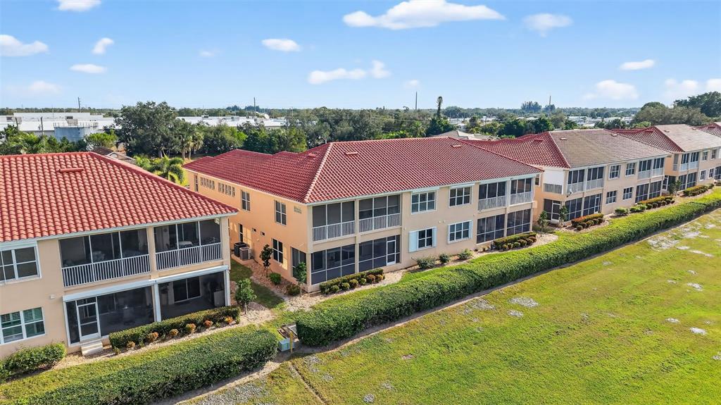 3959 San Rocco Drive, Unit 412 Punta Gorda, FL 33950 - Photo 35 of 41 a front view of a building with a garden and plants