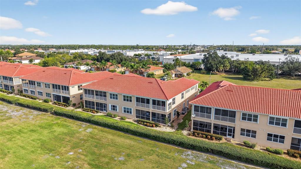 3959 San Rocco Drive, Unit 412 Punta Gorda, FL 33950 - Photo 40 of 41 a front view of a building with a garden and lake view