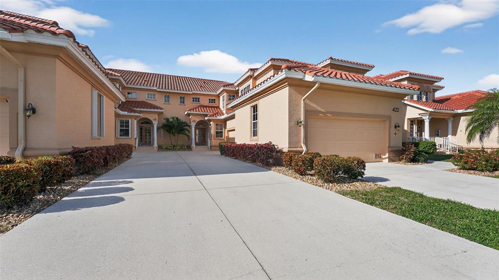 3959 San Rocco Drive, Unit 412 Punta Gorda, FL 33950 - Photo 4 of 41 a front view of a house with a yard and potted plants