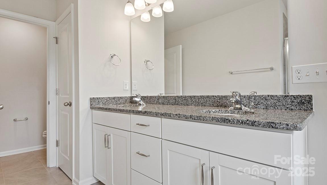 347 Lagoon Road Fletcher, NC 28732 - Photo 23 of 28 a bathroom with a granite countertop sink and a mirror