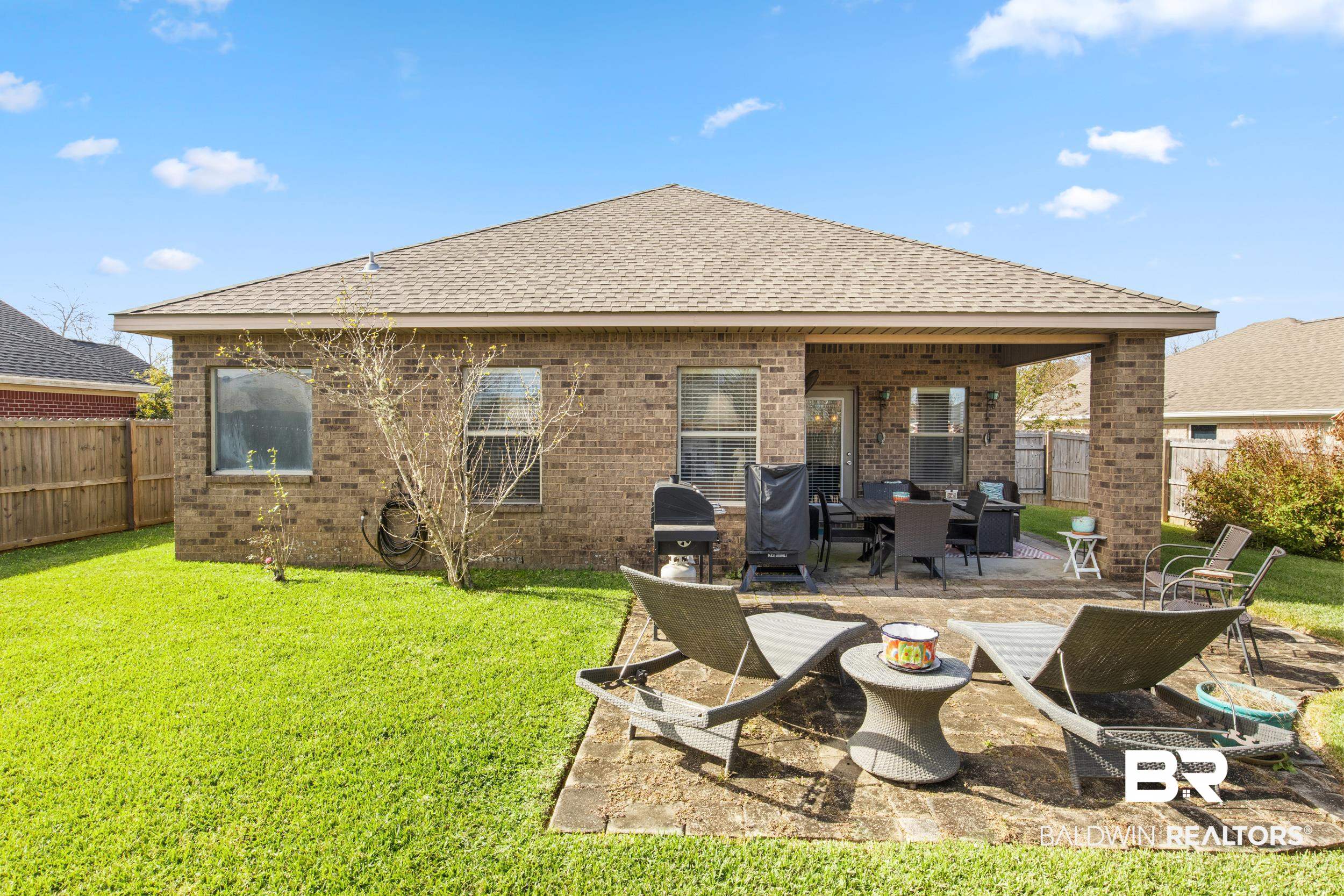 1752 Abbey Loop Foley, AL 36535 - Photo 16 of 21 Rear view of house with a lawn, outdoor lounge area, and a patio