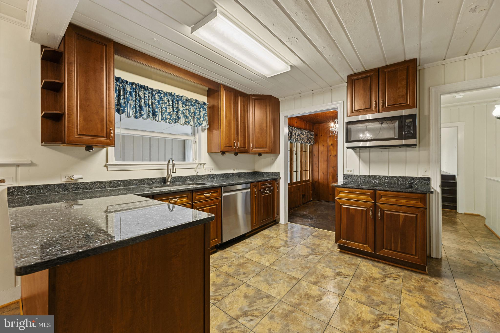 9265 Ramey Road Marshall, VA 20115 - Photo 26 of 49 a kitchen with granite countertop stainless steel appliances and wooden cabinets