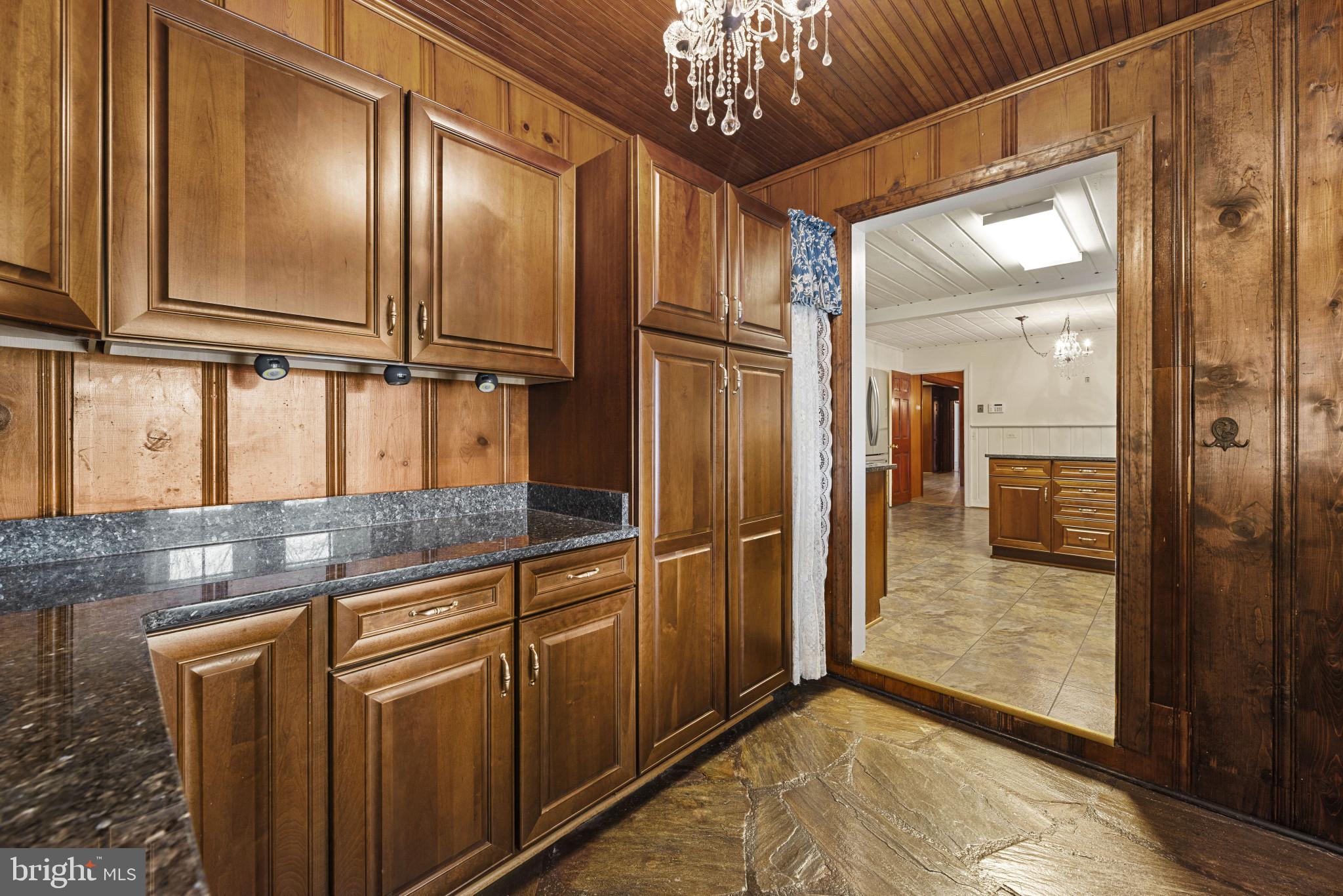 9265 Ramey Road Marshall, VA 20115 - Photo 29 of 49 a view of a hallway with granite countertop a refrigerator and a chandelier