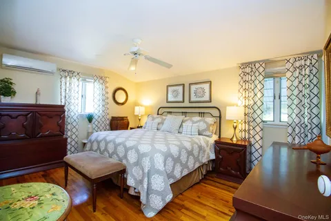 a bedroom with a bed window and couch