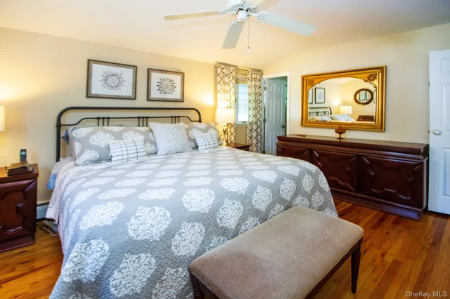 a bedroom with a bed and painting on the wall