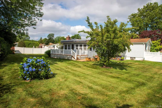 a balcony with wooden floor table and chairs