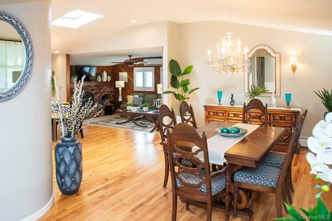 a dining room with furniture and a floor to ceiling window