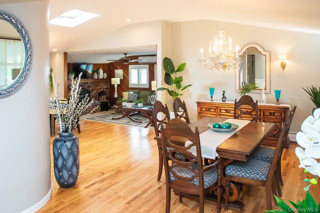 a dining room with furniture and a floor to ceiling window