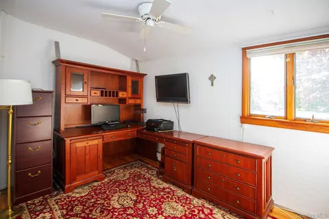 a kitchen with stainless steel appliances granite countertop a stove top oven a sink dishwasher a dining table and chairs with wooden floor