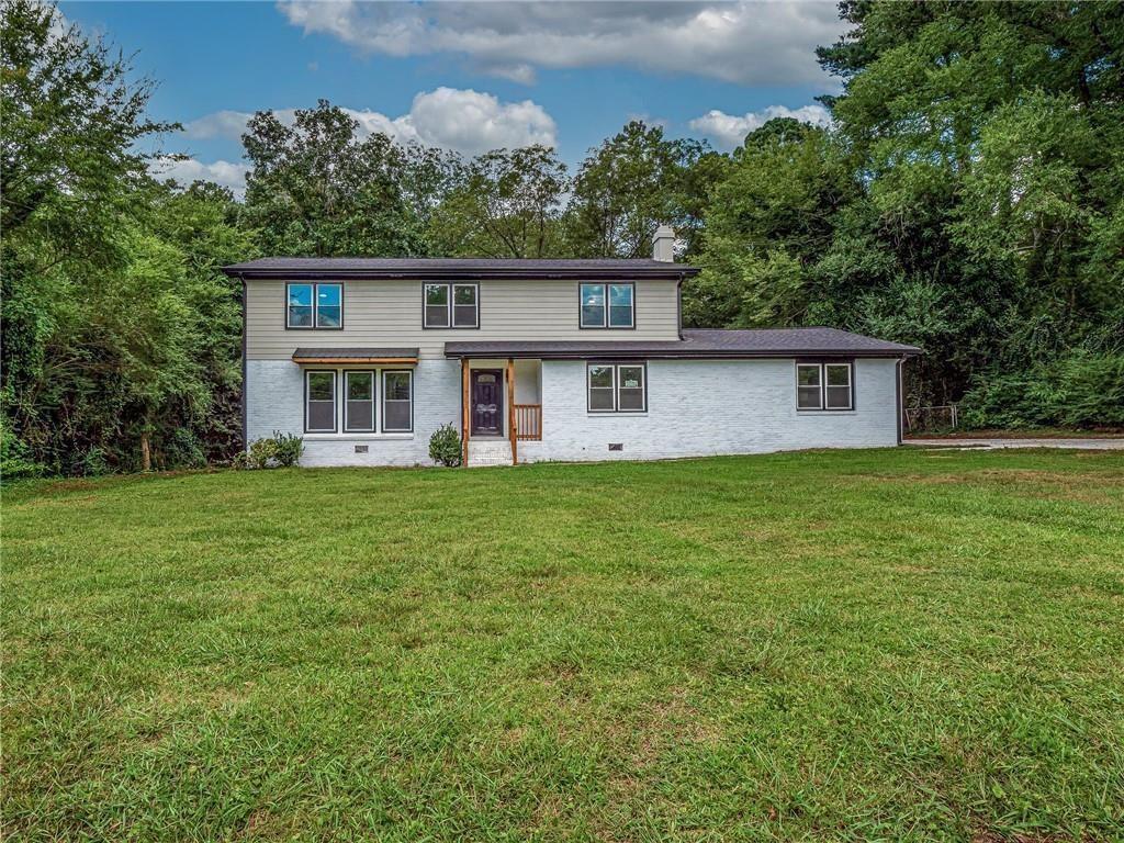 4505 Myrtle Hill Road Northeast Kennesaw, GA 30144 - Photo 1 of 27 a front view of house with yard and trees in the background