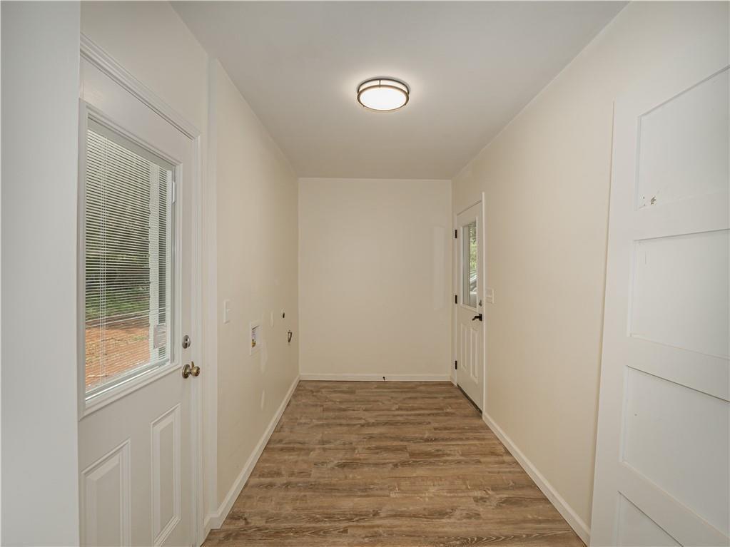 4505 Myrtle Hill Road Northeast Kennesaw, GA 30144 - Photo 14 of 27 a view of a hallway with wooden floor and a bathroom
