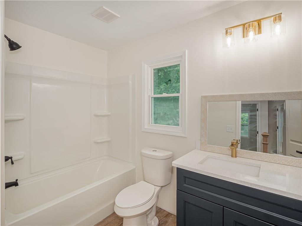 4505 Myrtle Hill Road Northeast Kennesaw, GA 30144 - Photo 20 of 27 a bathroom with a sink a toilet and shower