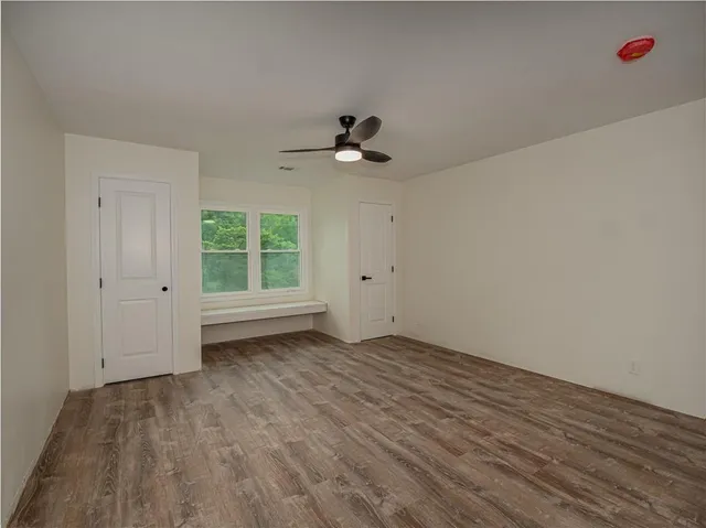wooden floor in an empty room with a window