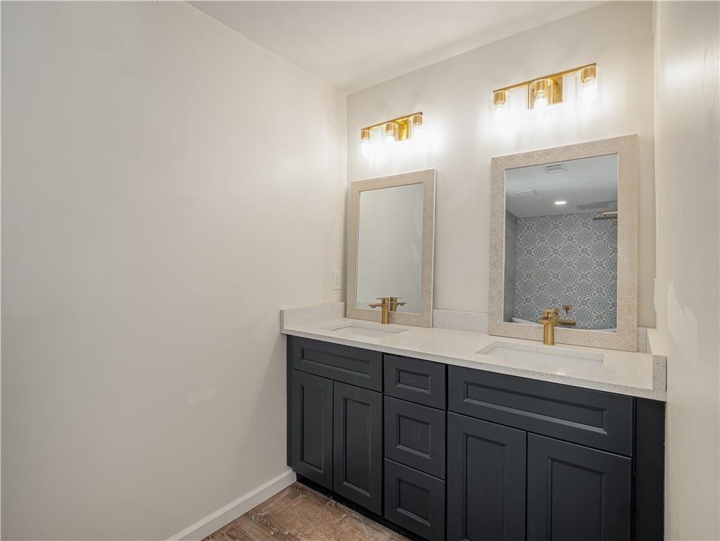4505 Myrtle Hill Road Northeast Kennesaw, GA 30144 - Photo 24 of 27 a bathroom with a double vanity sink and a mirror