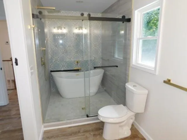 a bathroom with a toilet and a shower