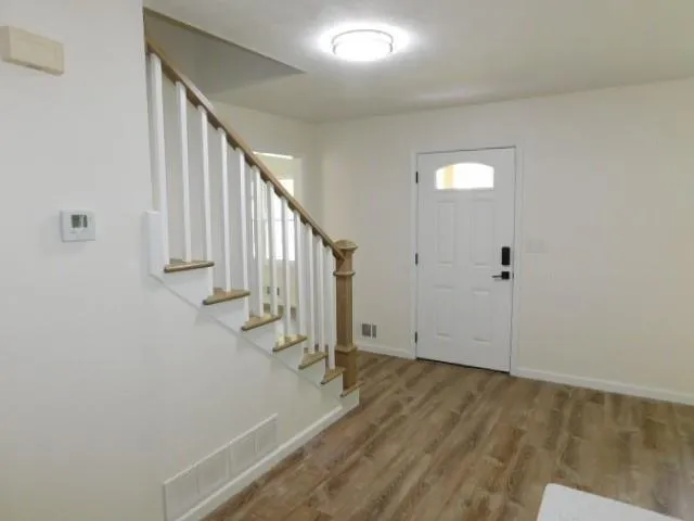 a view of entryway with wooden floor