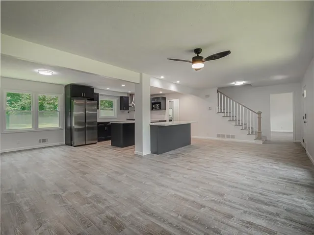 a view of a kitchen with a sink and a refrigerator