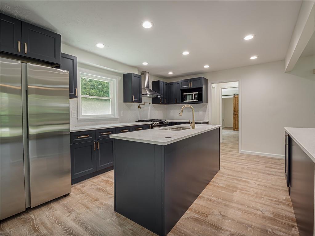 4505 Myrtle Hill Road Northeast Kennesaw, GA 30144 - Photo 8 of 27 a kitchen with kitchen island stainless steel appliances a sink stove and refrigerator