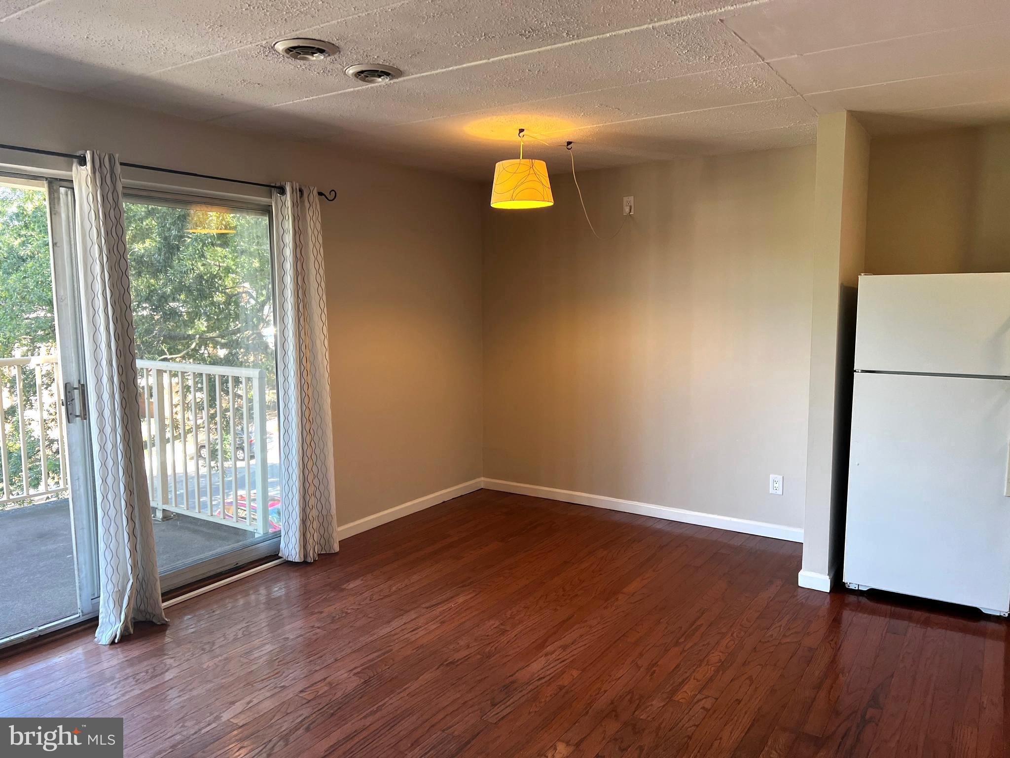 2638 Fort Farnsworth Road, Unit 121 Alexandria, VA 22303 - Photo 4 of 23 an empty room with wooden floor and windows