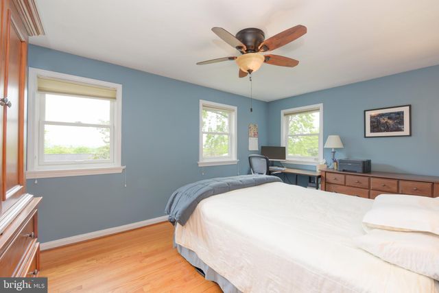 a spacious bedroom with a large bed and a window