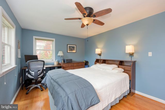 a bedroom with a bed and windows