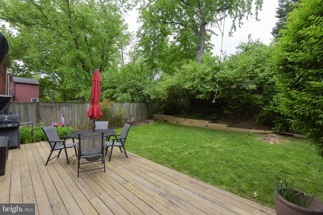 a view of a table and chairs in patio with wooden fence