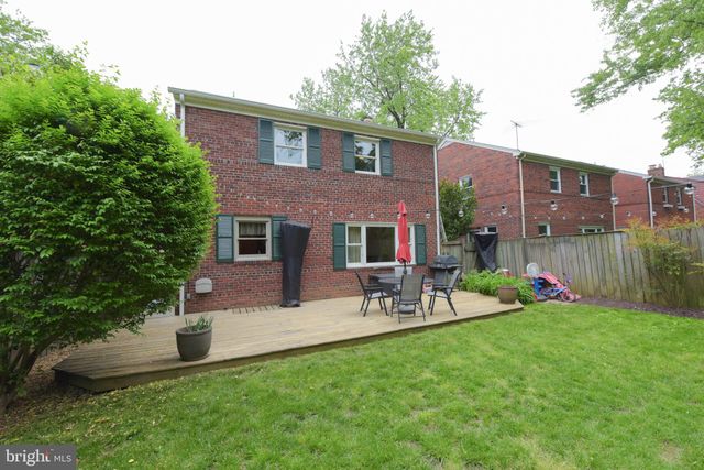 a view of a house with a backyard and a patio