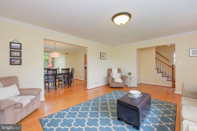 a living room with furniture a rug and a chandelier