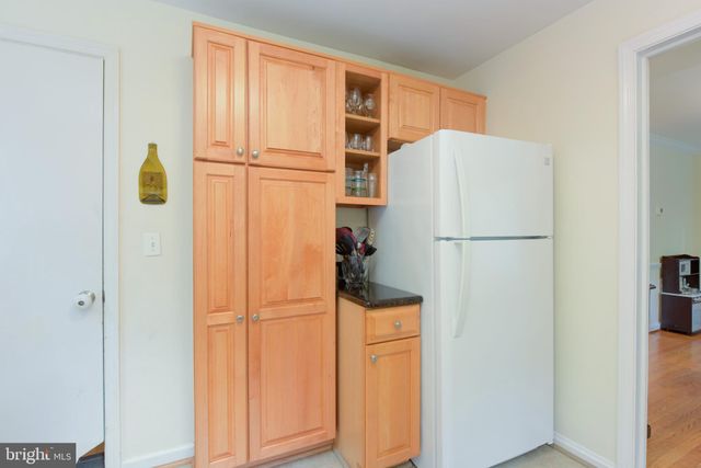 a white refrigerator freezer and a dishwasher with wooden floor