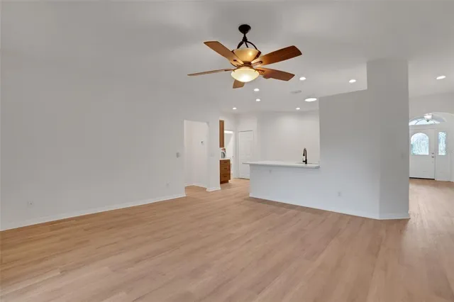 a view of an empty room with a ceiling fan