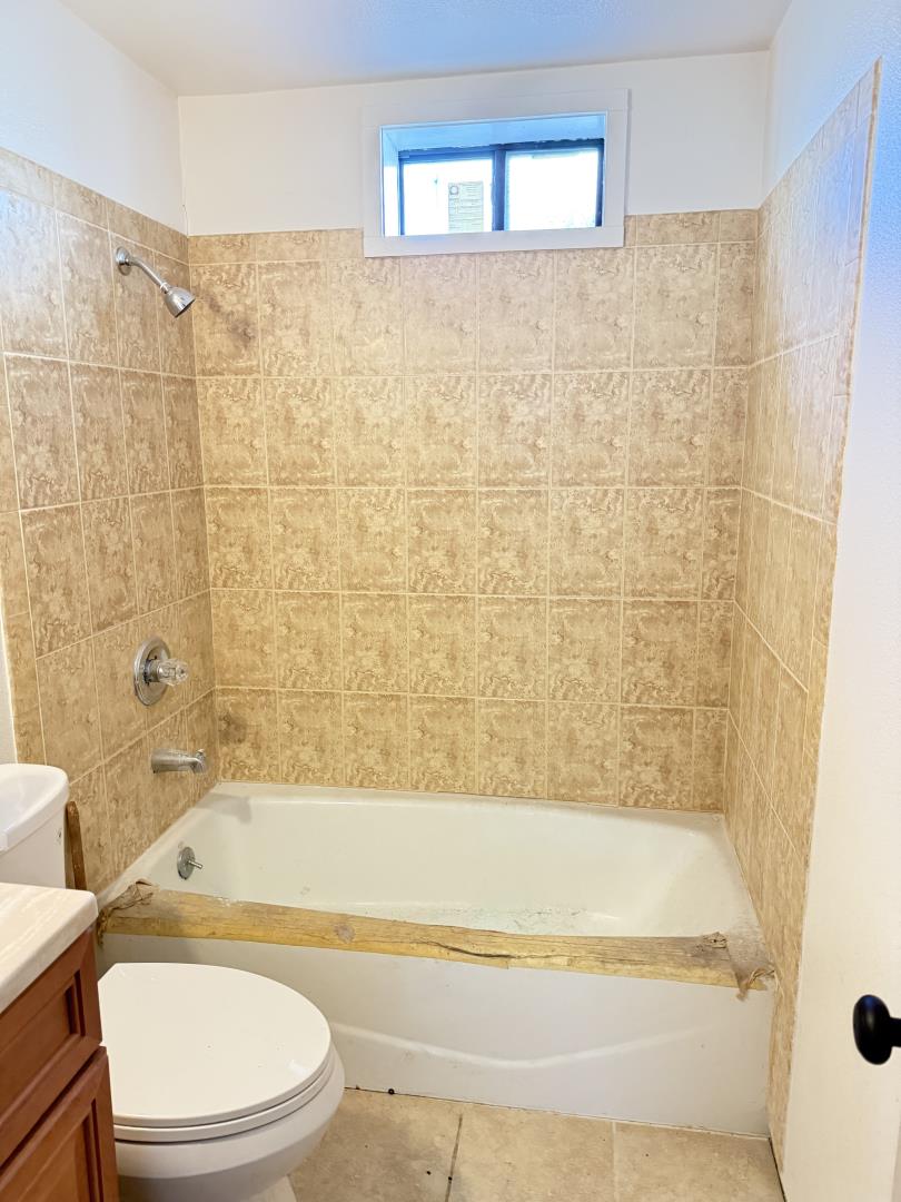 2841 Filbert Street Oakland, CA 94608 - Photo 3 of 8 a bathroom with a bathtub toilet and shower