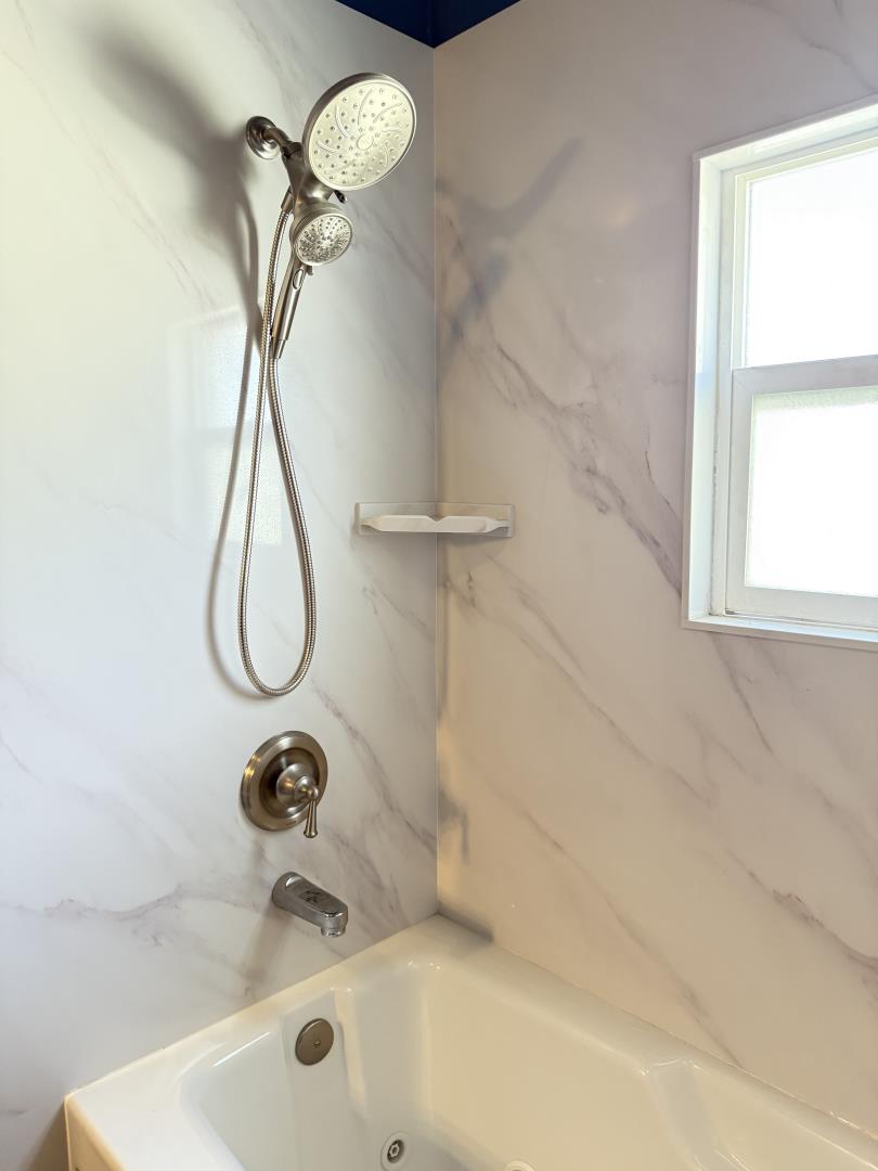 2841 Filbert Street Oakland, CA 94608 - Photo 4 of 8 a bathroom with a sink a mirror and a window