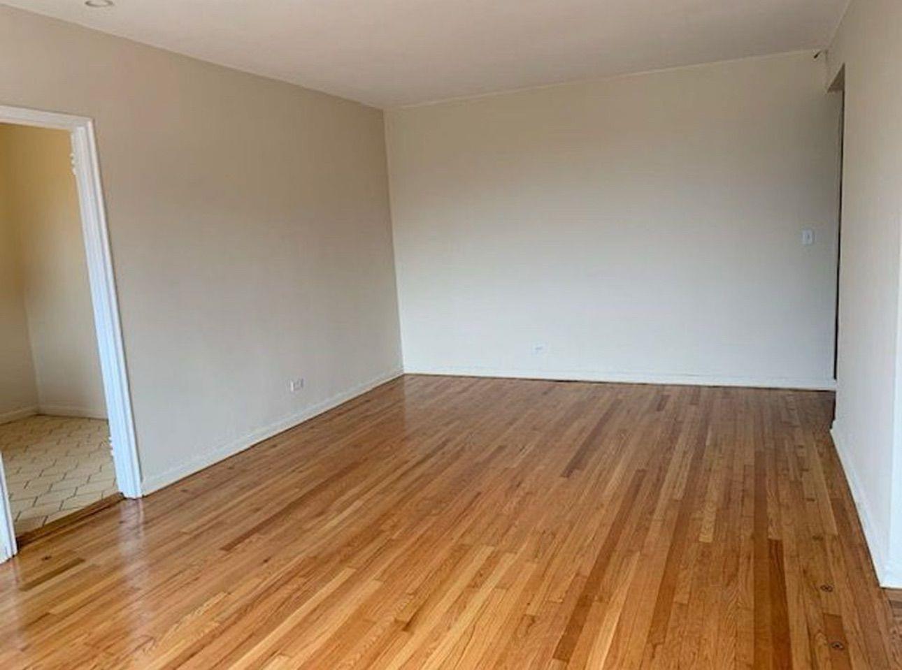 98-76 Queens Boulevard, Unit 6L Queens, NY 11374 - Photo 3 of 5 Empty room featuring light wood-style flooring and baseboards