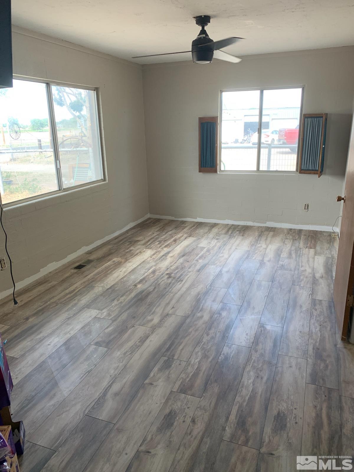 2975 Lone Tree Road Fallon, NV 89406 - Photo 11 of 26 a view of empty room with wooden floor and fan