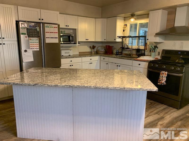 2975 Lone Tree Road Fallon, NV 89406 - Photo 4 of 26 a kitchen with stainless steel appliances granite countertop a sink stove and refrigerator